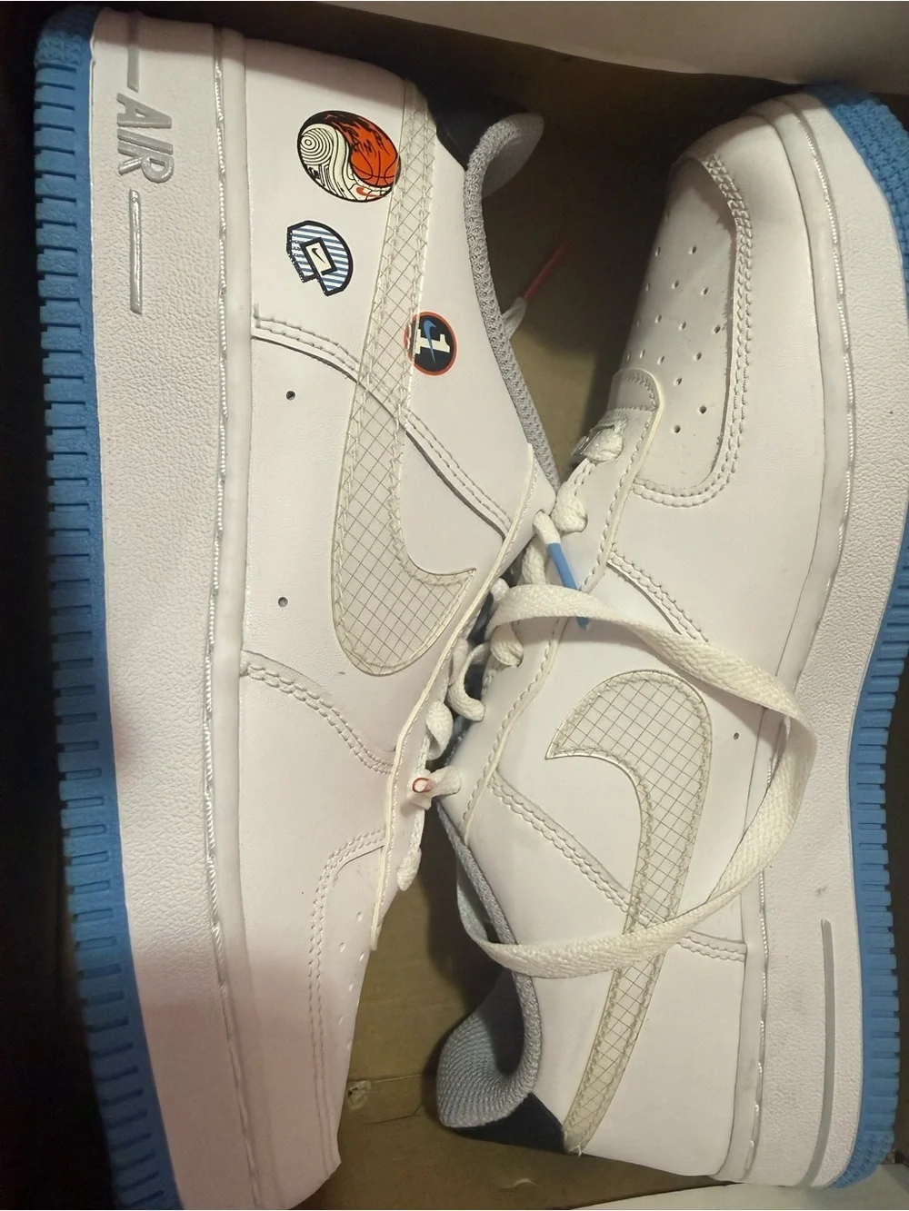Nike Kids White Leather Sneakers with Blue Outsole and Graphic Accents